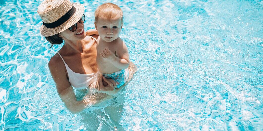 mother-with-little-son-having-fun-pool_1303-23036